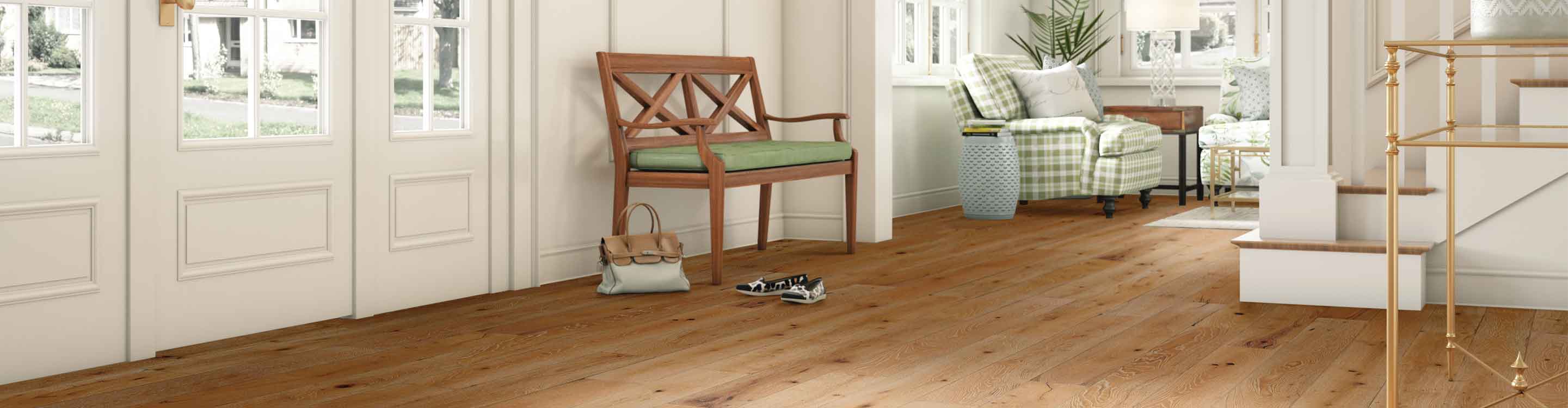 white entryway with hardwood flooring, wooden bench and green accents